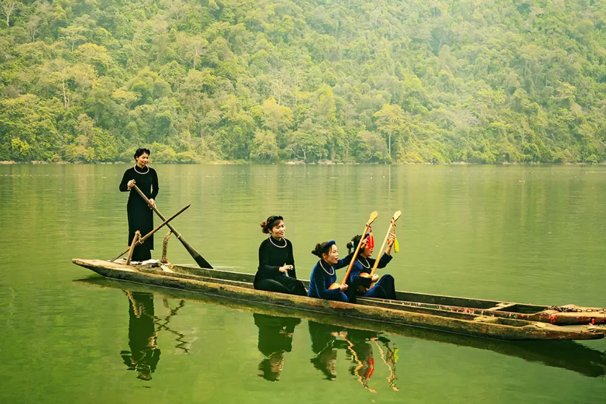 Boat cruising on the calm waters of Ba Be Lake in Northern Vietnam